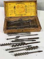 Open vintage wooden box showing inner yellow label and drill bits inside