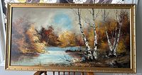 Front view of the full framed oil painting showing autumn birch trees and river scene.