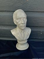 Front view of marble bust showing detailed facial features and suit of Pierre Elliot Trudeau