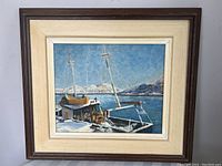Framed oil painting showing harbor with boats and mountains, portrait orientation