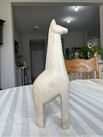 Front view of the soap stone giraffe sculpture showing its shape, size and condition.