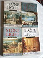 All 4 paperback books of The Stone of Light series with illustrated covers featuring ancient Egyptian scenes.