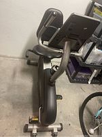 Side view of Pro-Form 55 recumbent exercise bike showing the seat, pedals, and partial console.