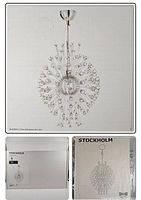 Photo of assembled IKEA STOCKHOLM chandelier showing spherical design with metal arms and glass beads.