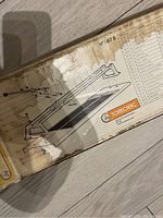 Photo of the box top showing the illustrated diagram and part list of the tile cutter, model No 567 S by Tomecanic.