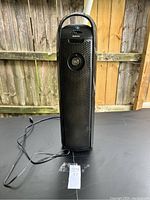 Front view of black Holmes Aero tower air purifier with power cord showing height and design