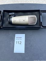 Behringer C-1 microphone placed inside black foam-lined protective case.