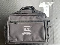 Front view of the black carrying bag with Glock logo and 'Perfection' text embroidered in white.