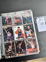 Front of binder pages showing multiple vintage NBA cards with players in basketball poses and jerseys