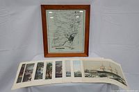 Framed Salisbury map and eight boat prints laid out in front of it.