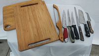 Photo shows two wooden cutting boards side by side, one with a handle and juice groove.