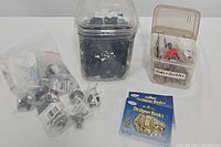 Overview of loose knobs and hardware, including round metal knobs and wrapped pieces.