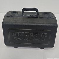 Closed black plastic Porter-Cable case with logo and kit name embossed on top, featuring carry handle and latches.