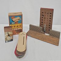 Photo showing 8-inch dovetail fixture wooden base, metal components, wood gauge extension block and original packaging