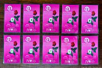 Top view of 10 pink Benchmark Strategic Metals packages, each containing a 1/4 grain .999 fine gold bullion bar.