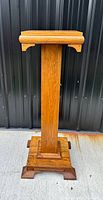 Full view of the antique oak plant stand pedestal showing footed base and vertical column body