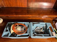 Black & Decker 7611 router kit shown inside original molded plastic case with power cord and accessory compartments.