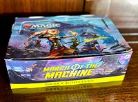 Box closed showing colorful artwork and product branding for Magic: The Gathering March of the Machine Draft Boosters.