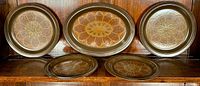 Full view of all five stoneware pieces: 2 luncheon plates, 2 dessert plates, and 1 oval serving platter, all decorated with the floral 'Marbella' pattern on a dark brown background.