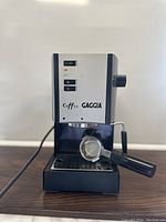 Full front view of the Gaggia espresso machine showing front panel controls and portafilter inserted.