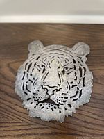 Front angled view showing detailed tiger head design and silverplate finish with tarnish.