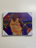 Front view of the colorful Kobe Bryant canvas print depicting him in Lakers jersey #24, showing vibrant colors and geometric background.