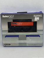 Front view of the RetroGEN adapter inside original packaging displaying the product name and image