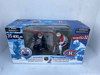 Front view of McFarlane NHL figure set featuring Tommy Salo and Saku Koivu in original packaging showing window display with figures and hockey goal net.