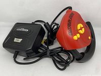 Sega Genesis console with connected red and yellow Marathon Man joystick controller and visible cords.