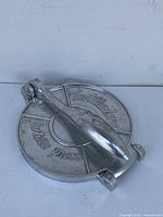 Photo of metal tortilla press bottom side showing embossing 'Tortilladora tortilla press'