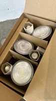 Photo of boxed light bulbs packed in cardboard packaging, showing 5 bulbs of different sizes.