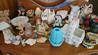 Various glass and ceramic figurines and trinket boxes including blue hobnail glass vase, floral ceramics, and small decorative figurines