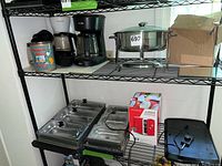 Shelving with warming trays, chafing dish, boxed small appliance, decorative mirrors, and mini refrigerator