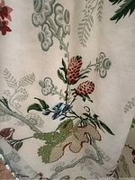 Close-up of botanical floral print on cream fabric