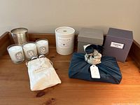 Overview of candles and soap items displayed on wooden surface