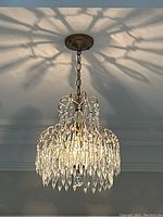 Chandelier viewed from side casting shadow on ceiling