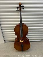 Full front view of cello standing upright