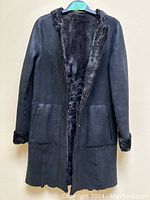 Front view with coat open showing shearling interior