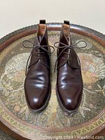 Top-down view of both boots on decorative tray