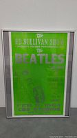 Framed green poster advertising The Beatles Ed Sullivan Show premiere Feb 9, 1964.