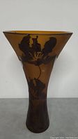 Side view of the large vintage art glass vase with floral designs etched or painted on its surface, showing the shape and color of the piece.