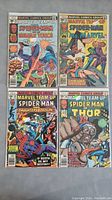 Four Marvel Team-Up comic books showing Spider-Man teaming with Human Torch, Ms. Marvel, Daughters of the Dragon, and Thor, all with typical wear.