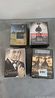 Four DVD cases including Pink Floyd The Dark Side of the Moon, Raging Bull, Sean Connery James Bond Collection, and The Gang of New York