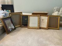 Wide shot of six 8x10 picture frames displayed on floor with glass inserts visible