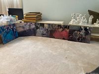 Five ballet-themed plaques arranged in a row on the floor, depicting various dance scenes in impressionistic style.