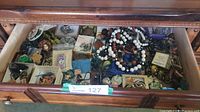 Drawer view of entire assortment of necklaces, bracelets, brooches, earrings and pins