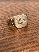 Front and side view showing engraved monogram on signet ring face and shoulder detail