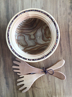 Top-down view of salad bowl interior grain and paired salad servers