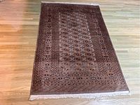 Full-view overhead shot of the entire rug laid flat on a wood floor