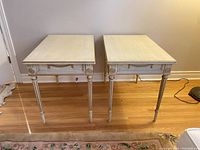 Front view of both side tables on hardwood floor against wall